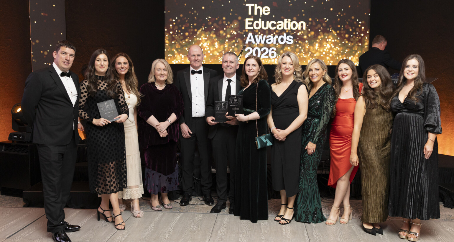 Eleven people dressed in black tie attire, at the Education Awards 2026.